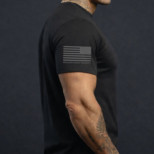 black tshirt with american flag on the sleeve.