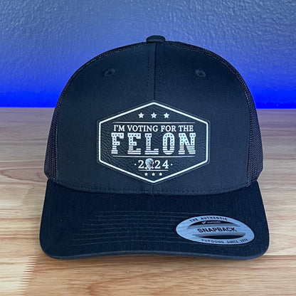 I'M VOTING FOR THE FELON Trump Face 2024 Leather Patch SnapBack Trucker Hat Black/Silver - Hollow Point Society - Patch Hat